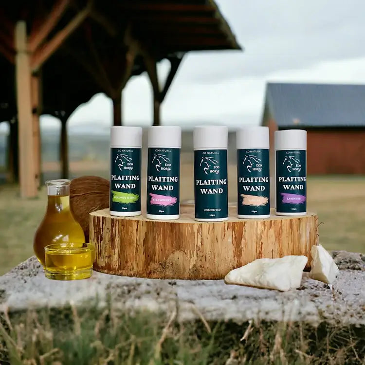 Eco Horse Plaiting Wands in cardboard tubes displayed on a wooden stump with olive oil for shiny horse mane care.