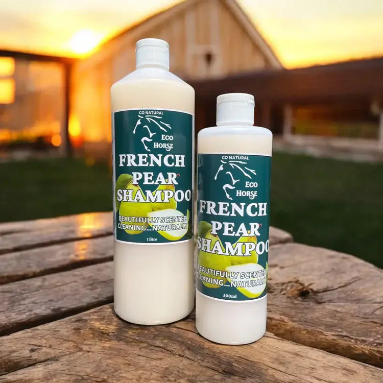 Eco Horse Frisky French Pear Shampoo bottles in natural outdoor setting, promoting gentle and natural horse grooming.