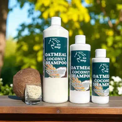 EcoHorse Oatmeal Coconut Shampoo bottles on a wooden table with coconut and oats in a natural outdoor setting.