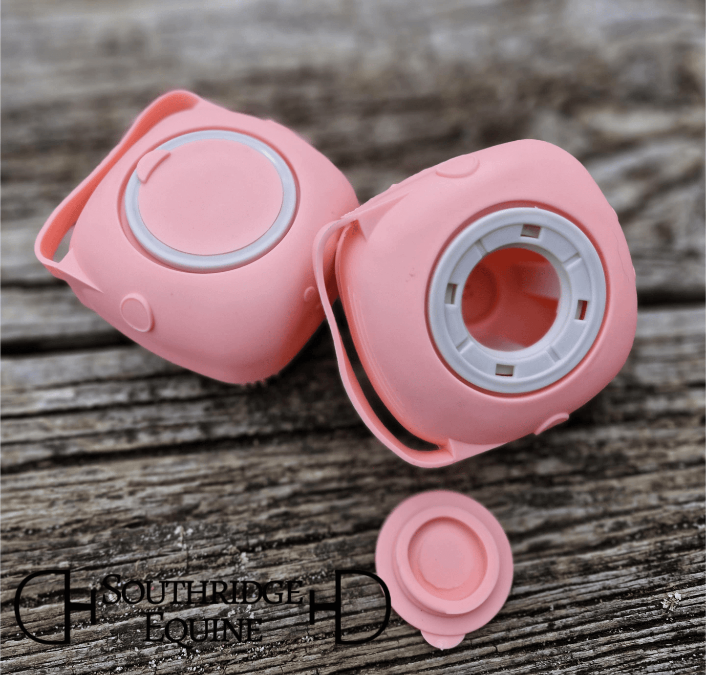 SE Sudsy Scrubber in pink color on a wooden surface, designed for easy shampoo dispensing during baths.
