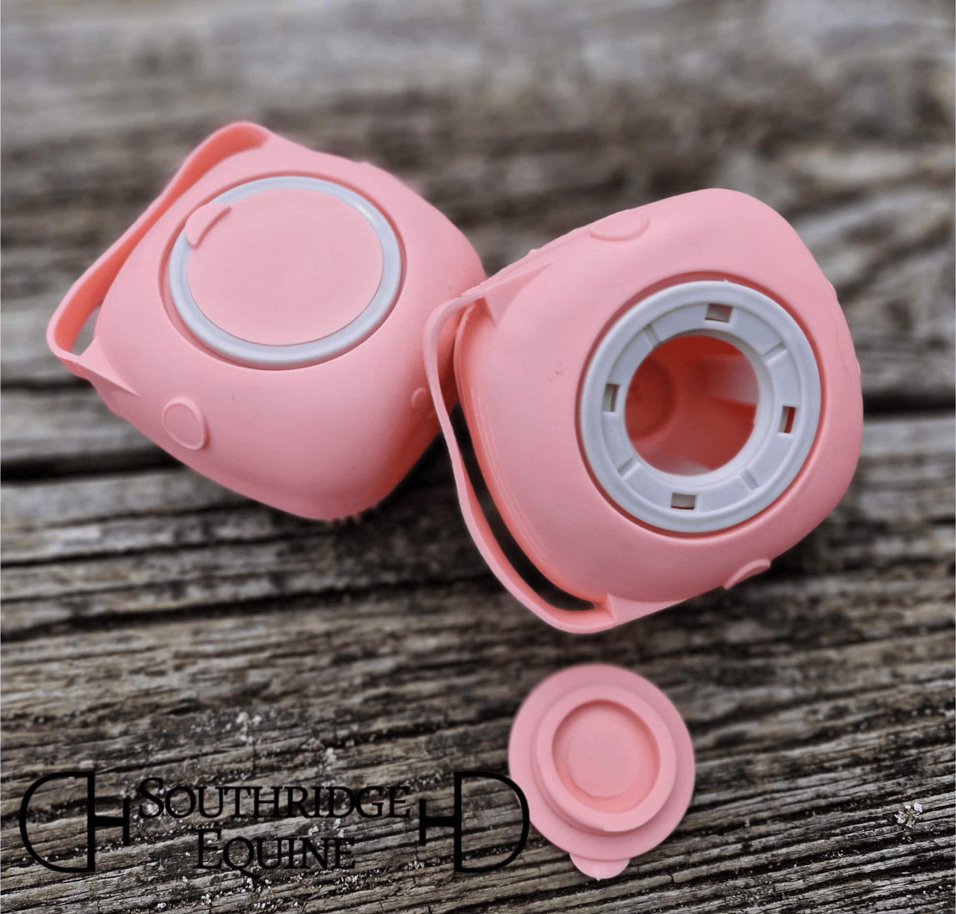 SE Sudsy Scrubber in pink color on a wooden surface, designed for easy shampoo dispensing during baths.